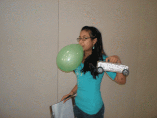 girl blowing up a balloon
